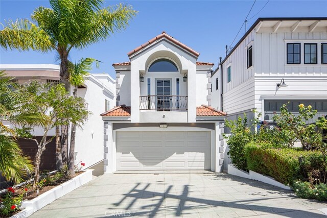 mediterranean / spanish-style home with a balcony and a garage