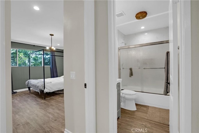 bathroom featuring bath / shower combo with glass door, recessed lighting, toilet, and wood finished floors