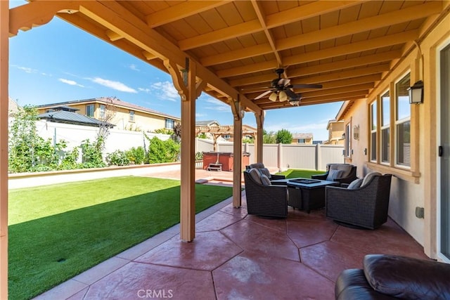 view of patio / terrace featuring ceiling fan and a hot tub