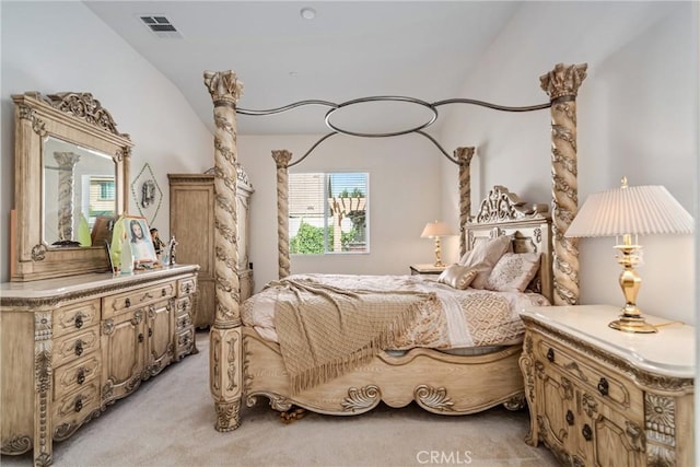 bedroom featuring light colored carpet and vaulted ceiling