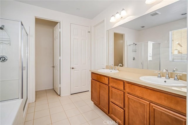 bathroom with vanity, tile patterned flooring, and plus walk in shower