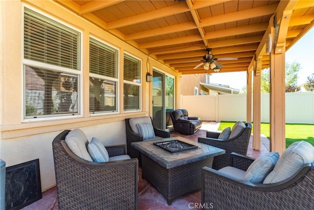 view of patio / terrace featuring ceiling fan and a fire pit