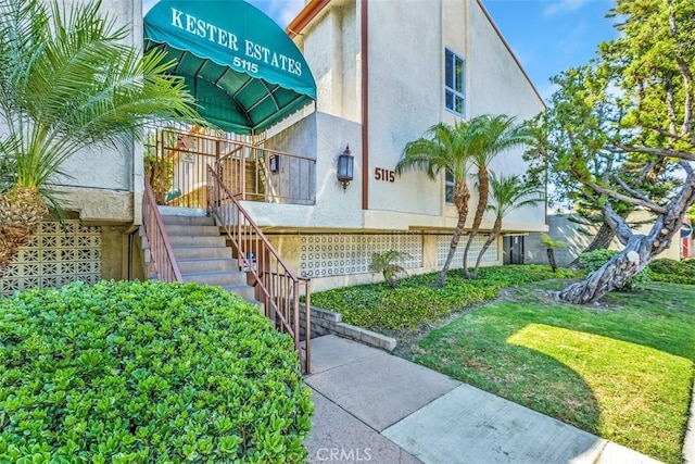 doorway to property featuring a lawn