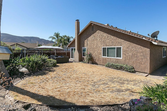 view of side of home featuring a patio and a mountain view