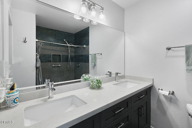 bathroom with toilet, vanity, and curtained shower