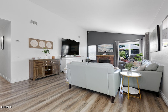 living room with wood-type flooring and lofted ceiling