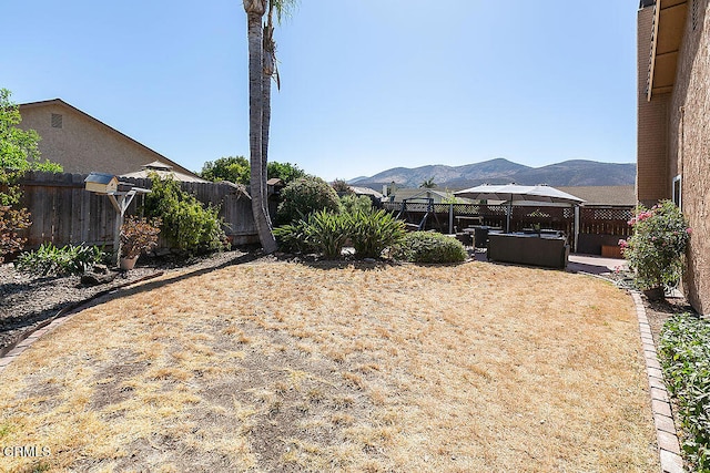 view of yard with a patio and a mountain view