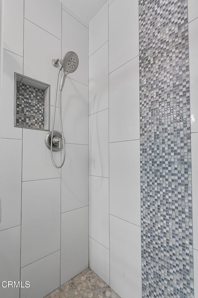 bathroom with a tile shower