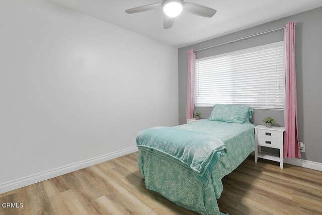 bedroom with hardwood / wood-style floors and ceiling fan