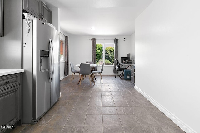 kitchen featuring stainless steel fridge and light tile patterned floors