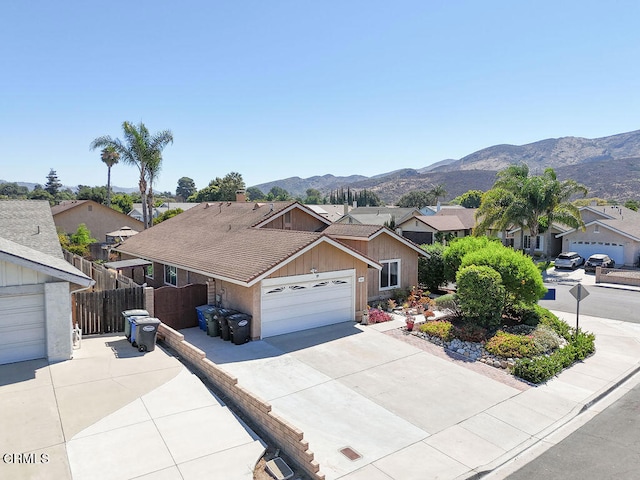 single story home with a garage and a mountain view