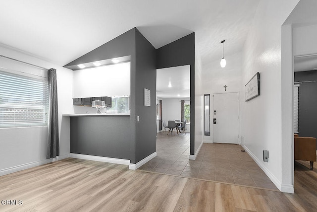 interior space featuring high vaulted ceiling and light wood-type flooring