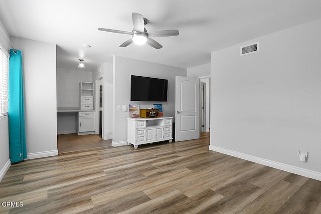 unfurnished living room with light hardwood / wood-style flooring and ceiling fan