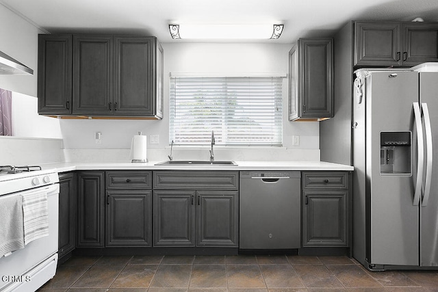 kitchen featuring sink, wall chimney range hood, and stainless steel appliances