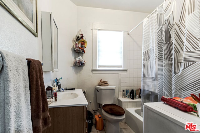 full bathroom featuring vanity, toilet, shower / bath combo with shower curtain, and tile patterned floors