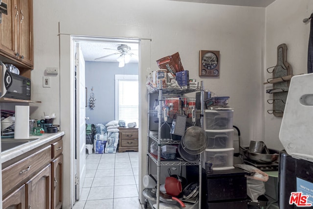 kitchen with ceiling fan and light tile patterned floors