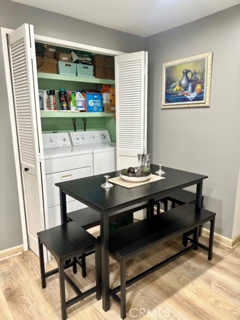 dining area featuring washing machine and clothes dryer and light hardwood / wood-style flooring