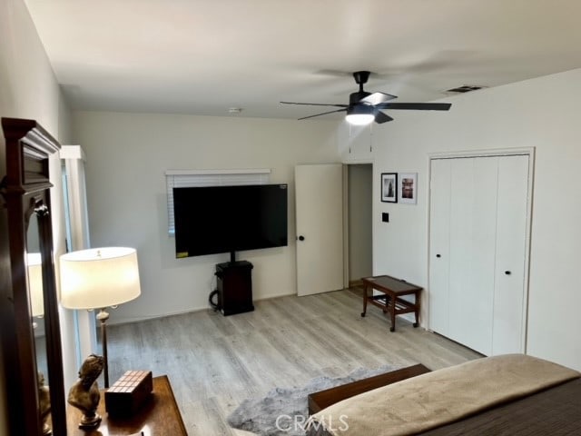 living room with ceiling fan and light hardwood / wood-style floors