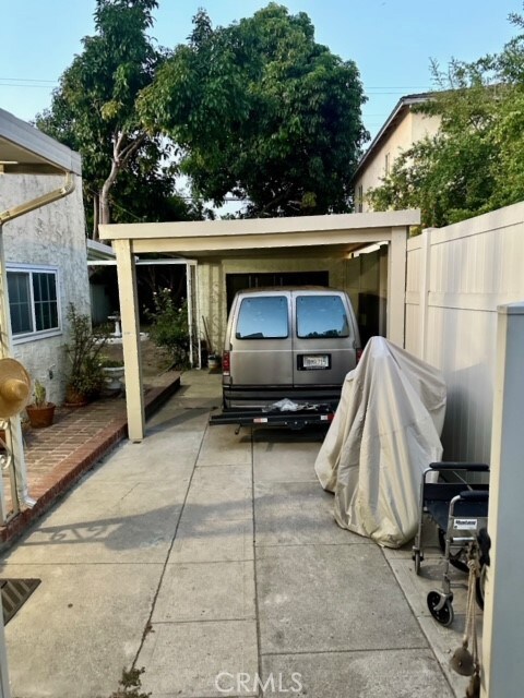 view of parking / parking lot featuring a carport