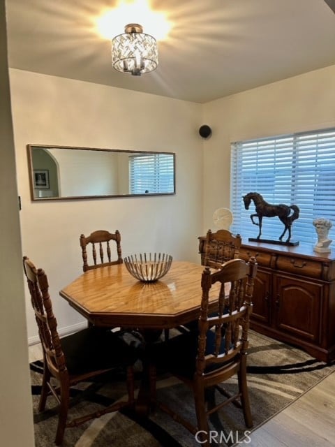 dining area featuring light hardwood / wood-style flooring and a chandelier