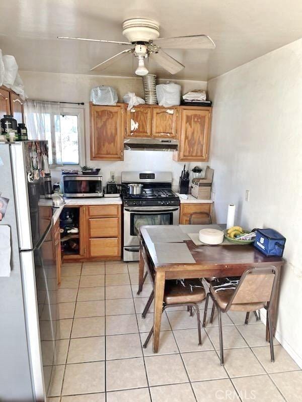 kitchen with ceiling fan, light tile patterned floors, and appliances with stainless steel finishes