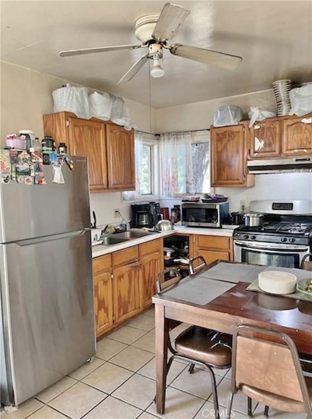 kitchen with ceiling fan, sink, light tile patterned floors, and appliances with stainless steel finishes