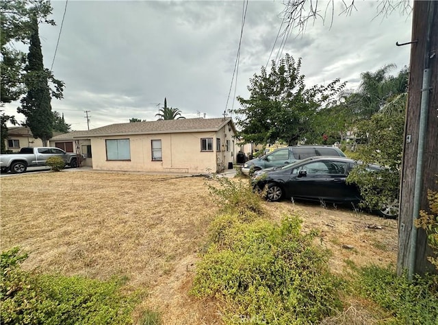 view of property exterior with a lawn