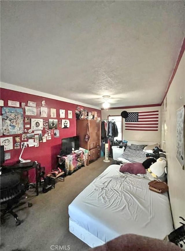 bedroom with carpet flooring, ornamental molding, and a textured ceiling