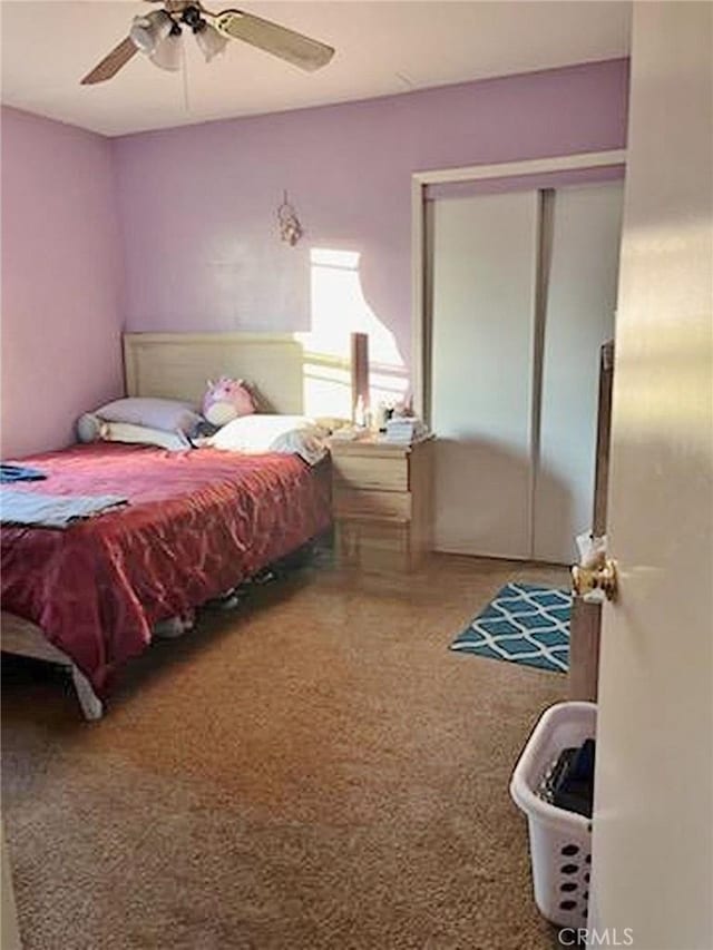 bedroom with ceiling fan and a closet