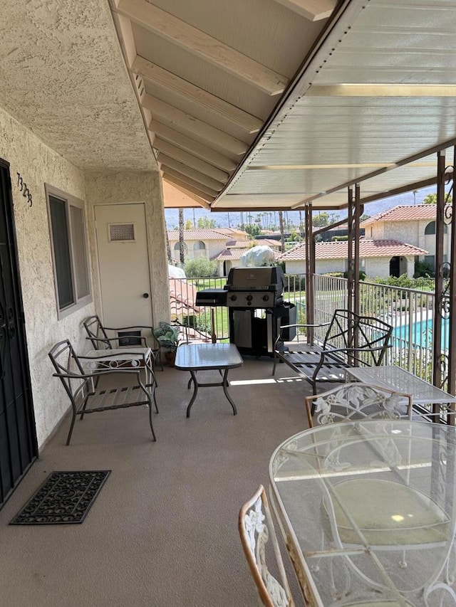 view of patio with a fenced in pool and a grill