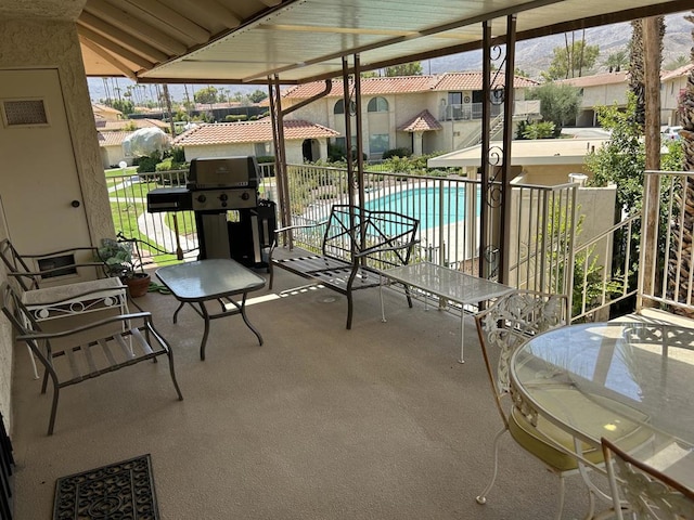 view of patio / terrace with area for grilling and a fenced in pool