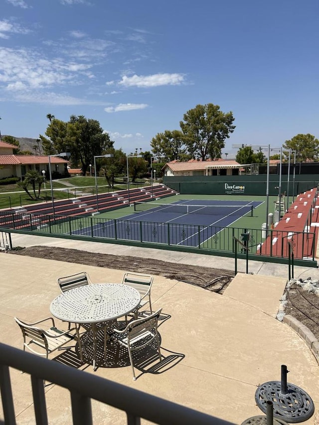 view of community featuring tennis court