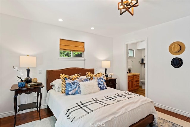 bedroom featuring ensuite bathroom and hardwood / wood-style floors