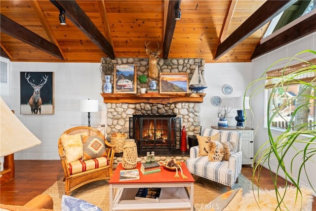 living room featuring wood ceiling, a stone fireplace, wooden walls, wood-type flooring, and lofted ceiling with beams