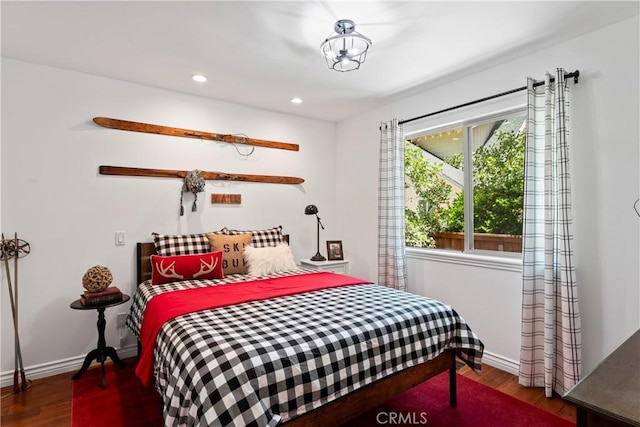 bedroom with dark wood-type flooring