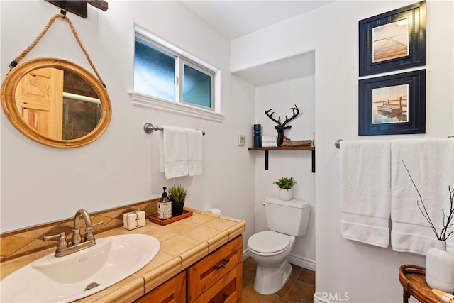 bathroom featuring toilet and vanity