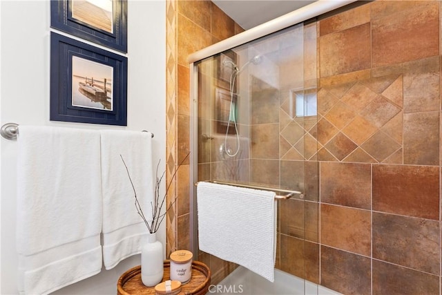 bathroom featuring a shower with door