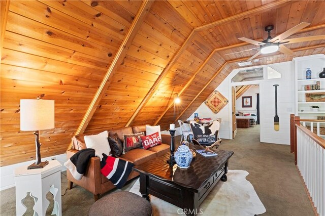 carpeted office space with ceiling fan, lofted ceiling with beams, wood ceiling, and wooden walls