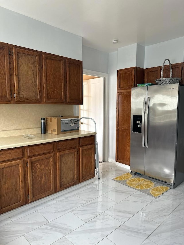 kitchen featuring stainless steel refrigerator with ice dispenser