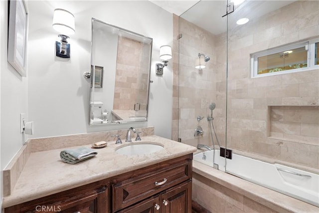 bathroom with vanity and shower / bath combination with glass door