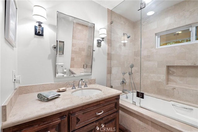 full bathroom featuring tiled shower / bath combo and vanity