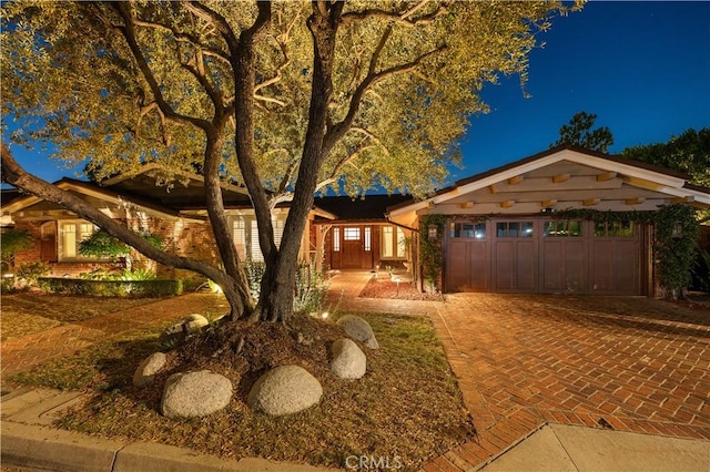 view of front of house with a garage and decorative driveway