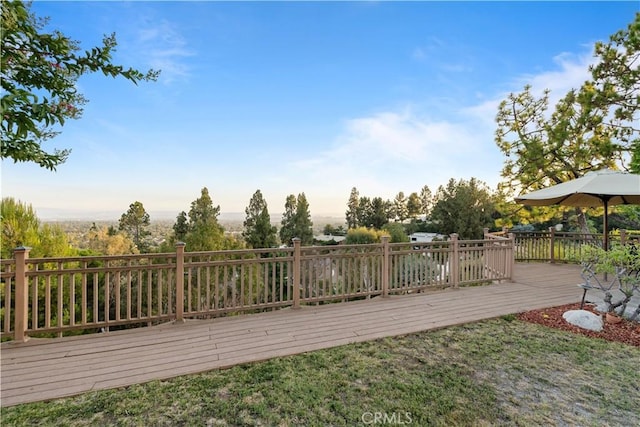 wooden deck featuring a yard