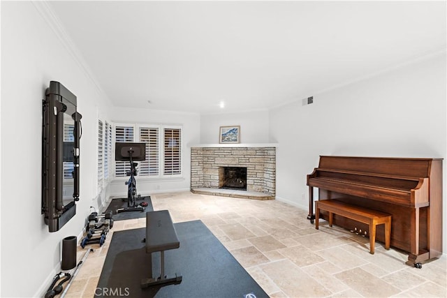 workout area with a fireplace, visible vents, ornamental molding, stone finish floor, and baseboards