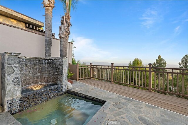 wooden terrace featuring a patio