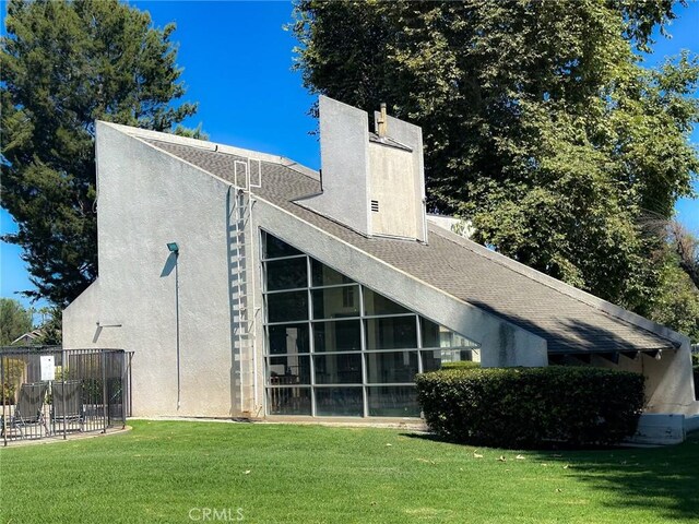 back of property featuring a lawn