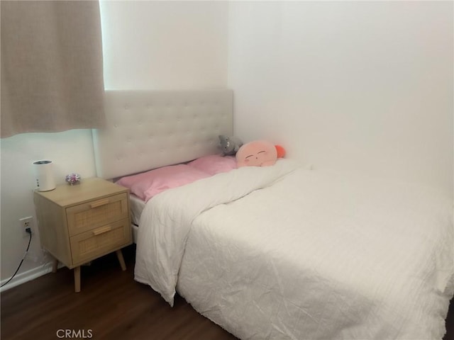 bedroom with dark wood-type flooring