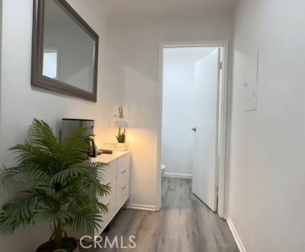 corridor with dark hardwood / wood-style flooring