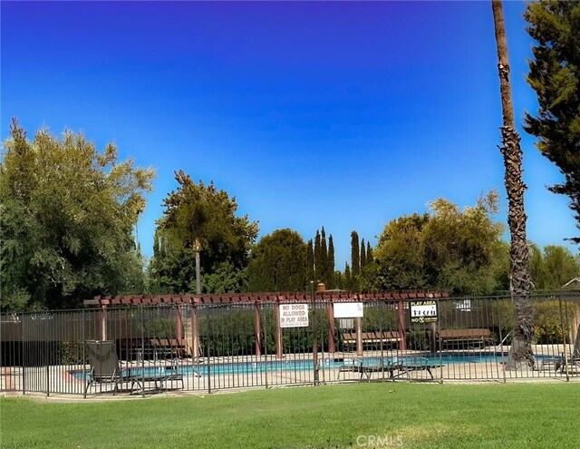 view of pool with a lawn