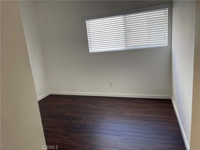 unfurnished room with dark hardwood / wood-style floors